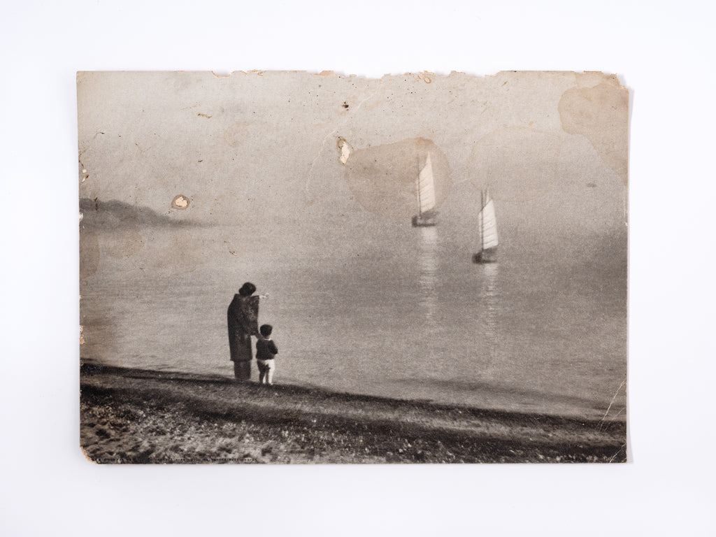 Photograph of woman and child on the shore, Japan