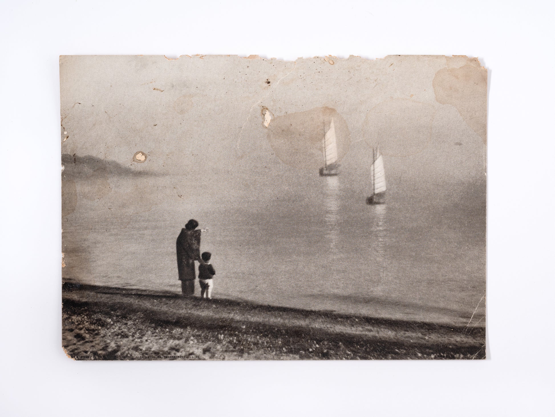 Photograph of woman and child on the shore, Japan